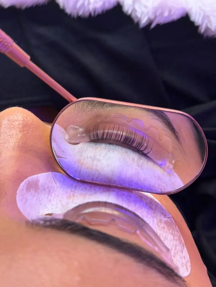 A Korean lash lift in progress, seen in a mirror