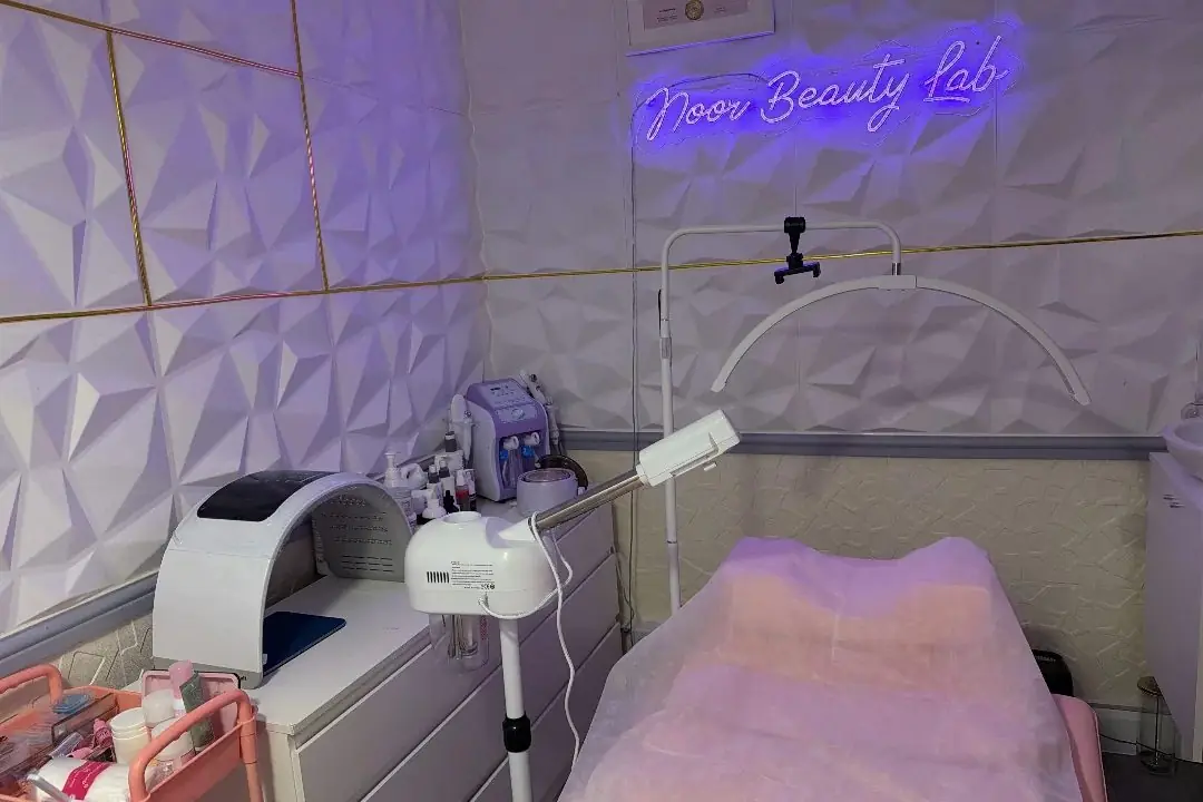 The Noor Beauty Lab treatment room with its neon sign